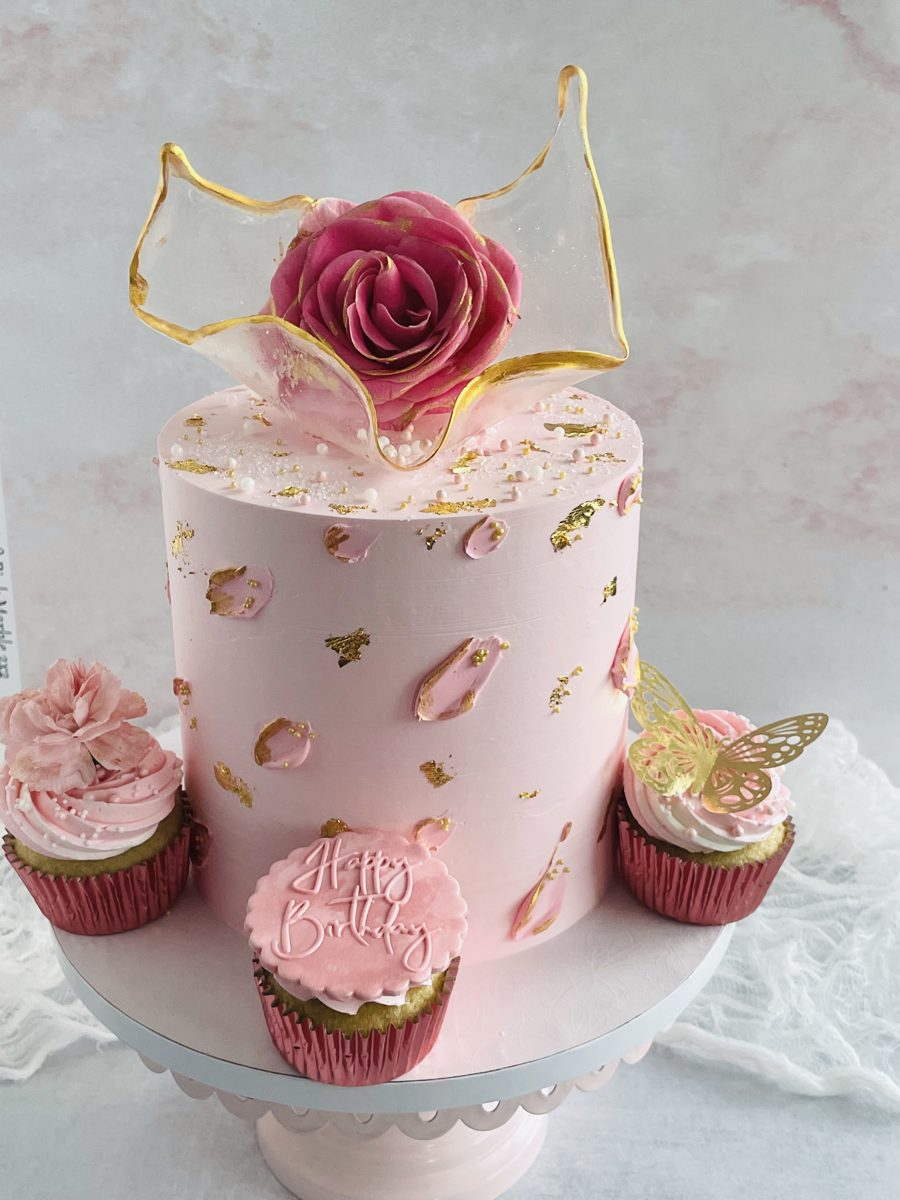 Blush birthday cake with a fresh pink rose and gold leaf, Hyderabad