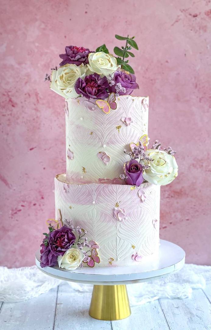 Herringbone buttercream cake with plum and white roses
