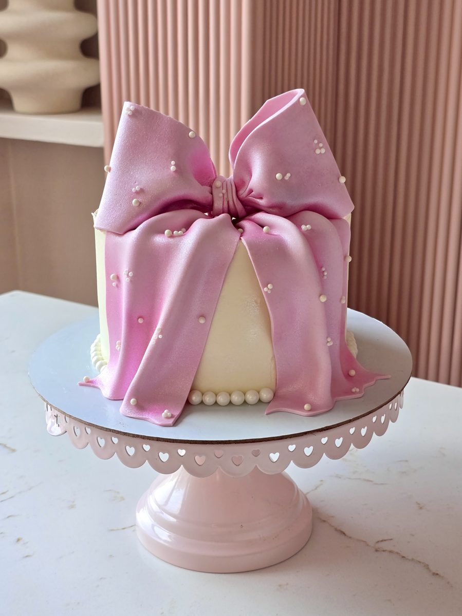 Blush pink celebration cake with a sculpted bow