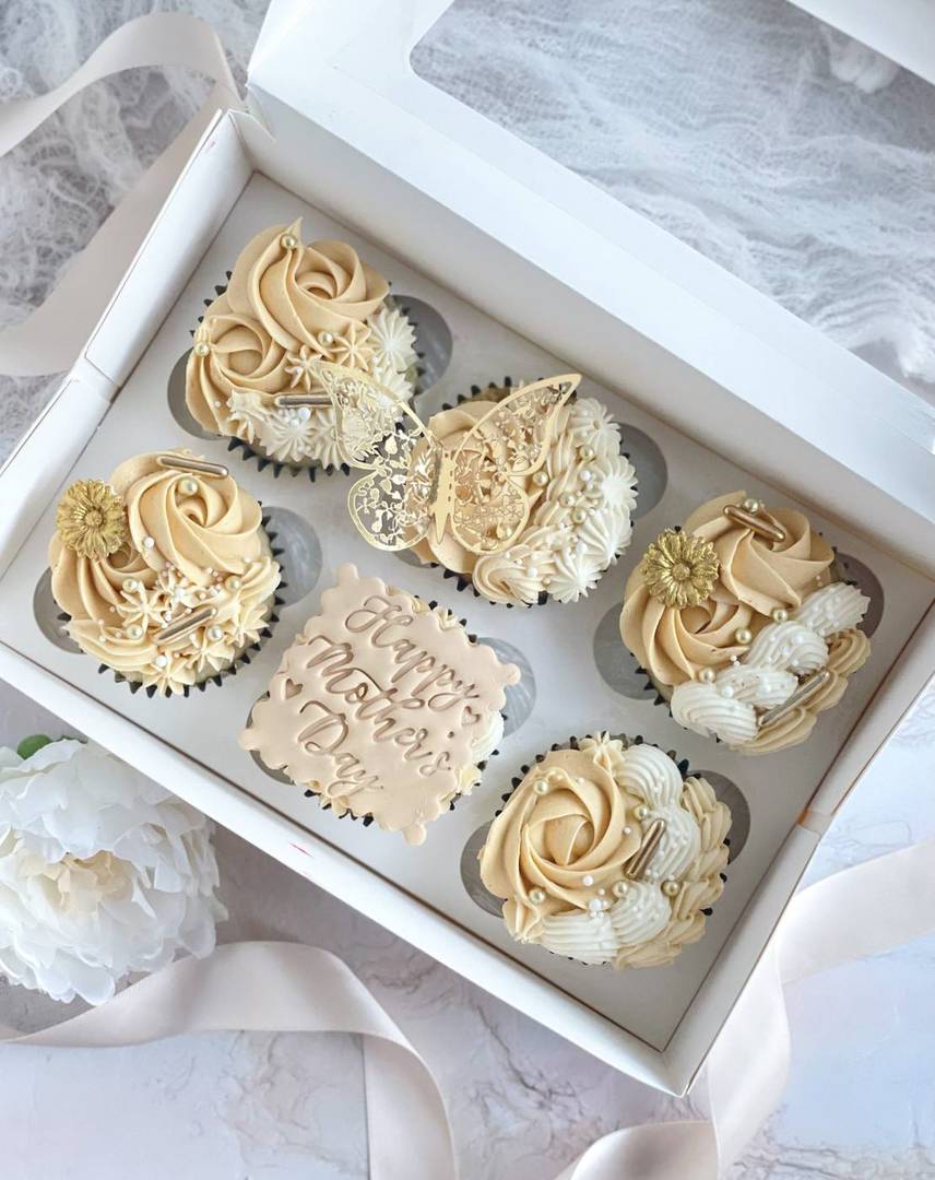 Ivory buttercream roses with a gold butterfly